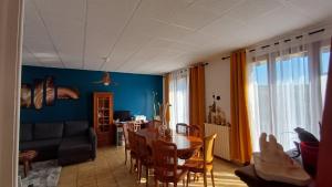 a living room with a table and a dining room at AïnaPat in Carmaux +32 photos