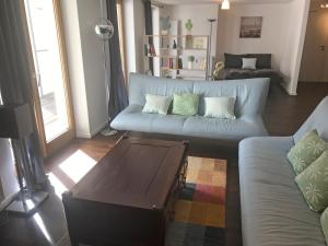 a living room with a couch and a coffee table at Ferienwohnungen Haus Castello App9 in Aschau im Chiemgau