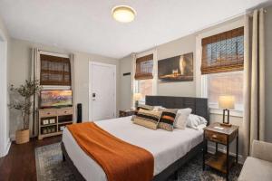 a bedroom with a large bed and two windows at Derby & Bourbon Trail Homebase W Private Backyard in Louisville