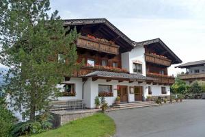 a house with flowers in front of it at Frühstückspension Schönblick in Ellmau