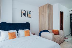 a bedroom with a bed and a chair at Work Friendly Studio near Nairobi CBD and Westlands in Nairobi