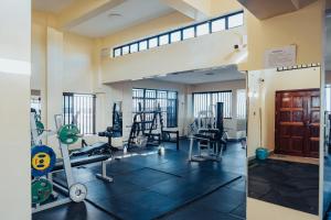 a gym with treadmills and machines in a room at Work Friendly Studio near Nairobi CBD and Westlands in Nairobi