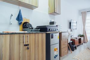 a kitchen with a stove and a refrigerator at Work Friendly Studio near Nairobi CBD and Westlands in Nairobi +19 photos
