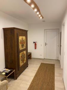 a living room with a large wooden cabinet and a rug at Stübchen Nr 37 in Inzigkofen