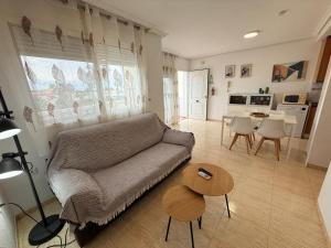 a living room with a couch and a table at Urbanización Torremar Natura in Vera