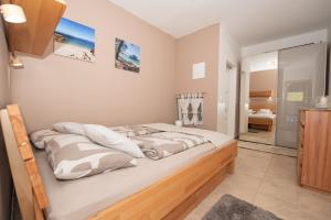 a bedroom with a large bed in a room at Laurentina - Modern Apartment with Large Terrace near Beach-quiet and comfortable in Sutivan
