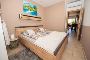 a bedroom with a large bed in a room at Laurentina - Modern Apartment with Large Terrace near Beach-quiet and comfortable in Sutivan