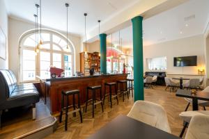 a restaurant with a bar with chairs and tables at martas Hotel Allegra Berlin in Berlin