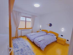 a bedroom with a bed and a large window at Panorama Sky Apartment -11 min by walk to Old Town - Free Parking in Sarajevo