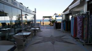 a patio with tables and chairs and a star on the ground at Aloha Paraíso in Torremolinos