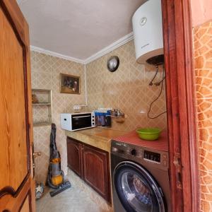 a kitchen with a washing machine and a microwave at Momo's villa in Aït Ourir