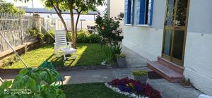 a yard with a chair and flowers in front of a house at Mirella's House in Padova