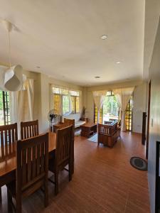 a living room with a dining room table and chairs at Island Nest in Virac