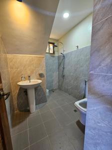 a bathroom with a sink and a shower and a toilet at Island Nest in Virac +24 photos