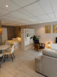 a room with a bed and a couch and a table at Studio 13 in Dronrijp