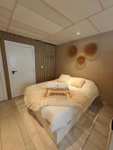 a bedroom with a large bed with a table on it at Studio 13 in Dronrijp
