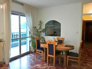 a dining room with a table and chairs and a balcony at Villa Terme in Grado