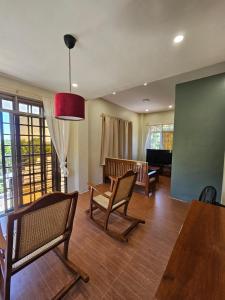 a living room with chairs and a table and a piano at Island Nest in Virac