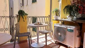 a small table and chairs on a balcony at Frem lord 5 terre in La Spezia