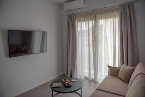 a living room with a couch and a table in front of a window at The ViewPoint VP3 in Mytilene