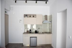 a kitchen with white cabinets and a sink at The ViewPoint VP3 in Mytilene