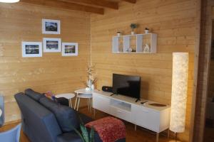 a living room with a couch and a television at Casa da Camélia in São Roque do Pico