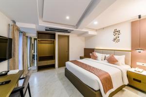 a hotel room with a bed and a desk at Hotel Star Place in Chennai