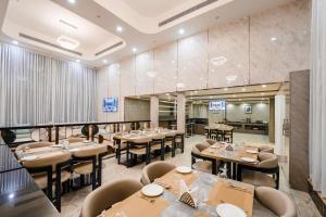 a restaurant with tables and chairs in a room at Hotel Star Place in Chennai +7 photos