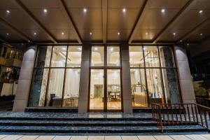 a building with glass doors and stairs in front at Hotel Star Place in Chennai
