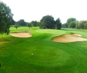 an aerial view of a golf course with two sand traps at Valgor -3 Bedroom House-Sleeps 5 with free parking-Ideal for contractors, families and group stays-WV6 in Tettenhall