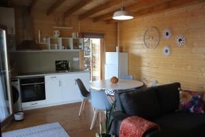 a living room with a table and a kitchen at Casa da Camélia in São Roque do Pico +22 photos