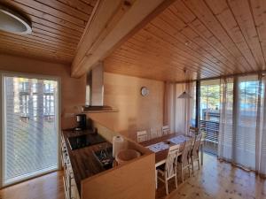 a kitchen with a table and chairs in a room at Tikankolo in Puumala