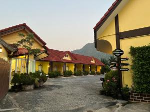 a row of buildings with a street sign in front at Rachawadee House Phang Nga in Phangnga