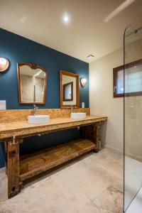 a bathroom with two sinks and two mirrors at Le Magasin à Poudre in Rocroi +1 photo