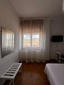 a bedroom with a bed and a window at Portal De La Rioja in Haro