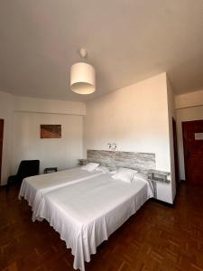 a bedroom with a large white bed in a room at Portal De La Rioja in Haro