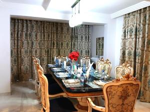 a dining room with a long table and chairs at Silva Montana in Mount Kenya