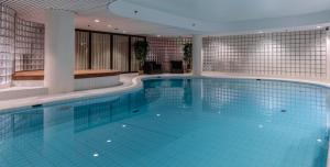 a large swimming pool in a hotel room at Lapland Hotels Oulu in Oulu