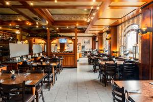 a dining room with wooden tables and chairs at Hotel Rebstock in Rust