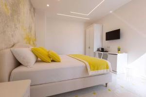 a bedroom with a bed with yellow pillows at Borgo Sant'Anna in Amalfi