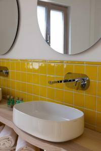 a bathroom with a white sink and a mirror at Borgo Sant'Anna in Amalfi +19 photos