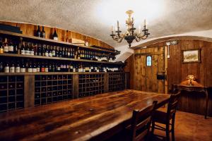 a bar in a room with bottles of wine at Hotel Planinka in Ljubno