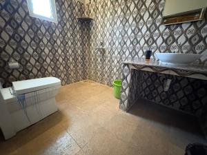 a bathroom with a sink and a toilet in it at Art cafe in Auroville +21 photos