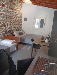 a bedroom with a bed and a desk and a table at Markos House 2 in Kalymnos +11 photos