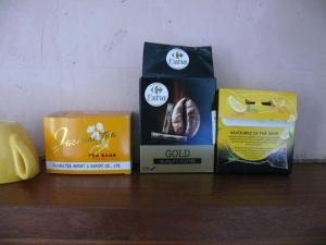 three boxes of food sitting on a wooden shelf at Shayton Natura in Aix-les-Bains +12 photos