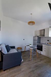 a living room with a couch and a table at La casa nel campo in Syros Island National Airport