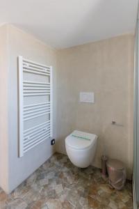 a bathroom with a white toilet in a room at La casa nel campo in Syros Island National Airport +22 photos