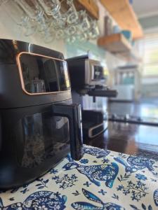 a microwave sitting on top of a table in a kitchen at Reebok Rest in Reebok