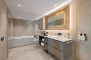 a bathroom with a sink and a toilet and a tub at Hotel SB Win 4 Sup in Sant Feliu de Llobregat