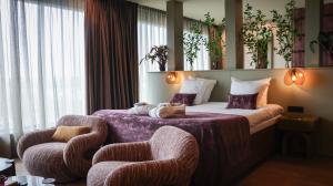 a hotel room with a bed and two chairs at Van der Valk hotel Veenendaal in Veenendaal +54 photos